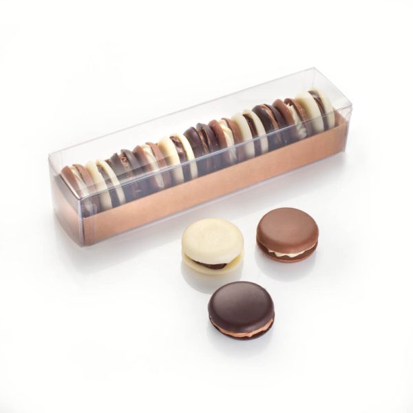 solid chocolate macrons in a long rectangle case with clear lid